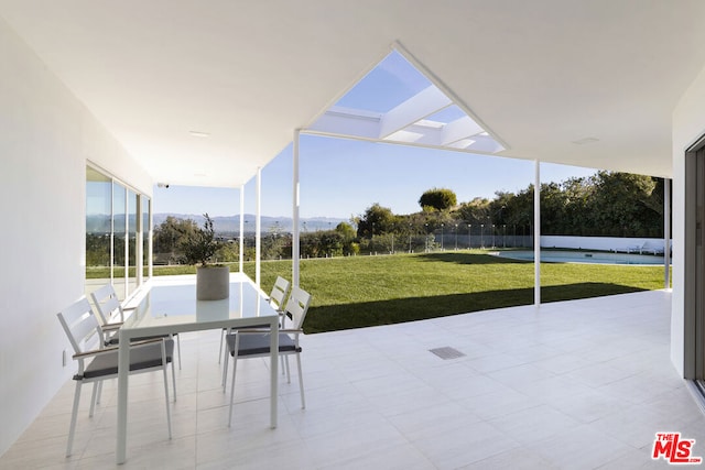 unfurnished sunroom with a mountain view