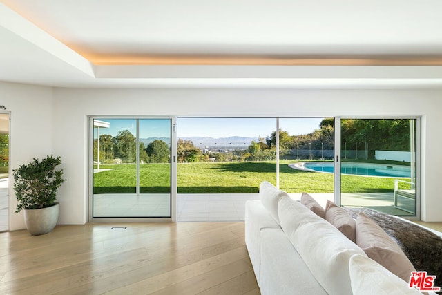 doorway to outside with light hardwood / wood-style floors and a mountain view