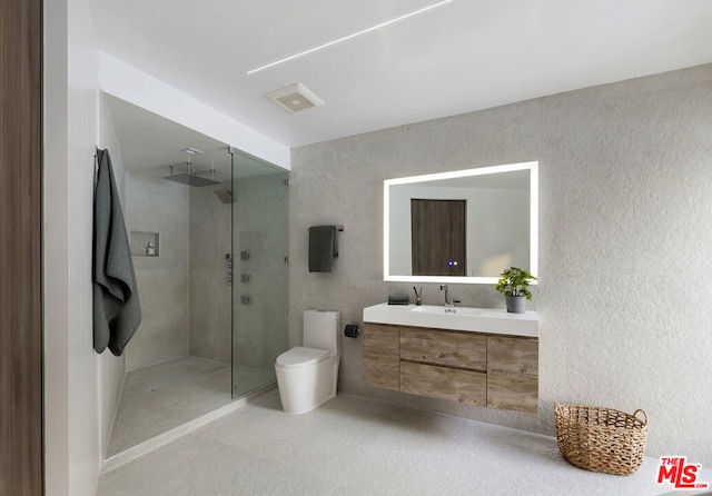 bathroom featuring toilet, an enclosed shower, and vanity