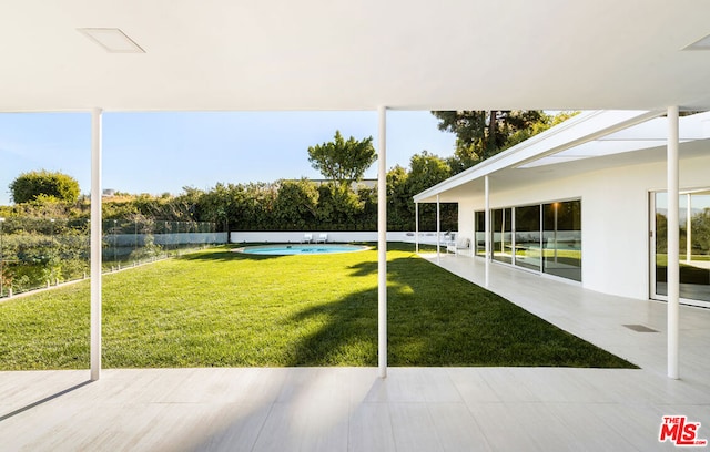 view of yard with a patio area and a fenced in pool