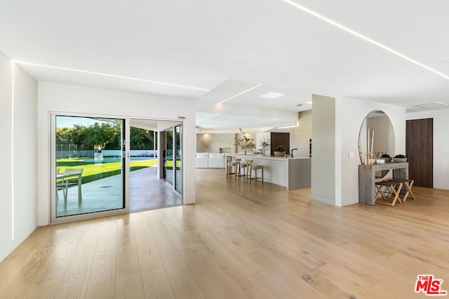 unfurnished living room with light hardwood / wood-style flooring