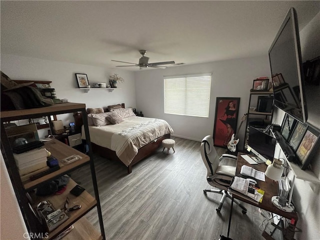 bedroom featuring hardwood / wood-style flooring and ceiling fan