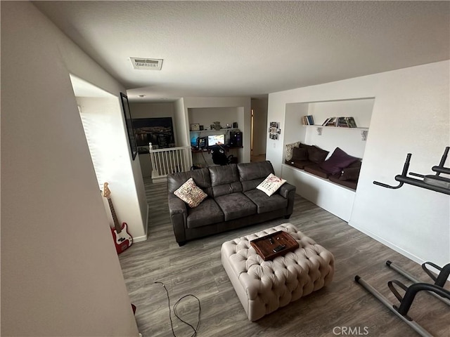 living room featuring hardwood / wood-style floors and a textured ceiling