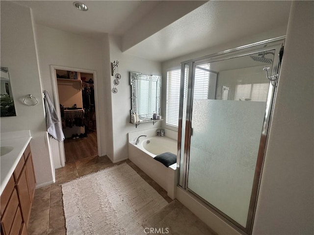 bathroom with tile patterned flooring, vanity, and independent shower and bath