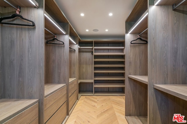 spacious closet featuring light parquet floors