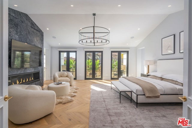 bedroom featuring french doors, light parquet floors, vaulted ceiling, and multiple windows