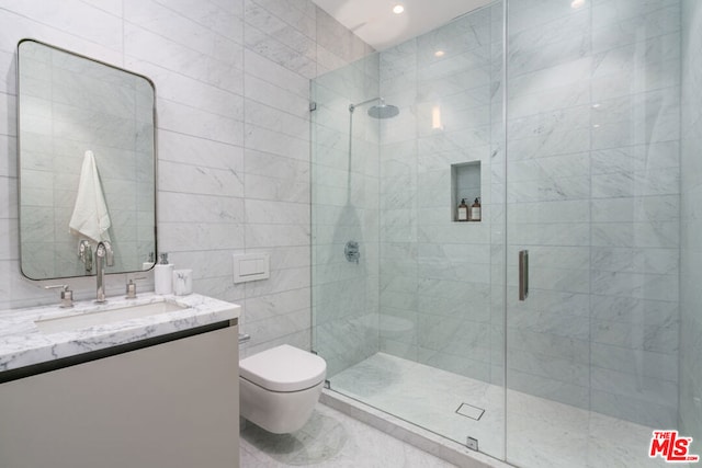 bathroom with vanity, toilet, and a shower with door