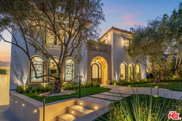 mediterranean / spanish-style house featuring a lawn