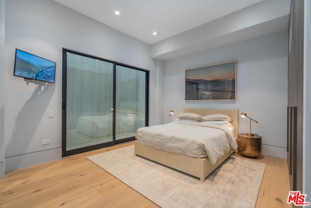 bedroom featuring access to outside and light hardwood / wood-style flooring