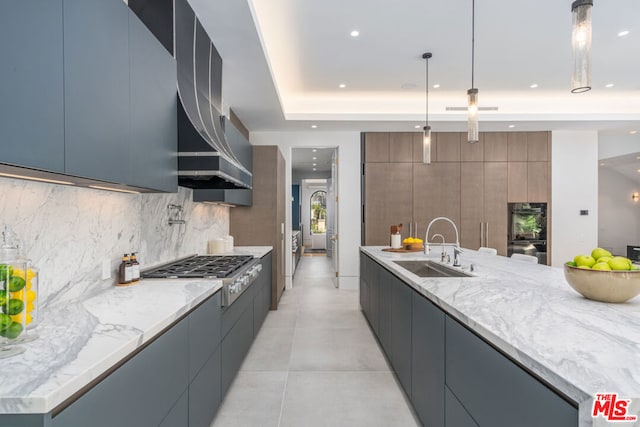 kitchen with decorative backsplash, stainless steel gas cooktop, sink, pendant lighting, and black double oven