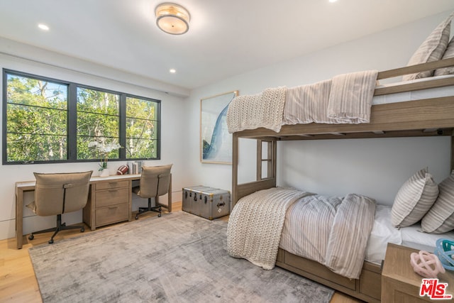 bedroom featuring light hardwood / wood-style flooring and built in desk