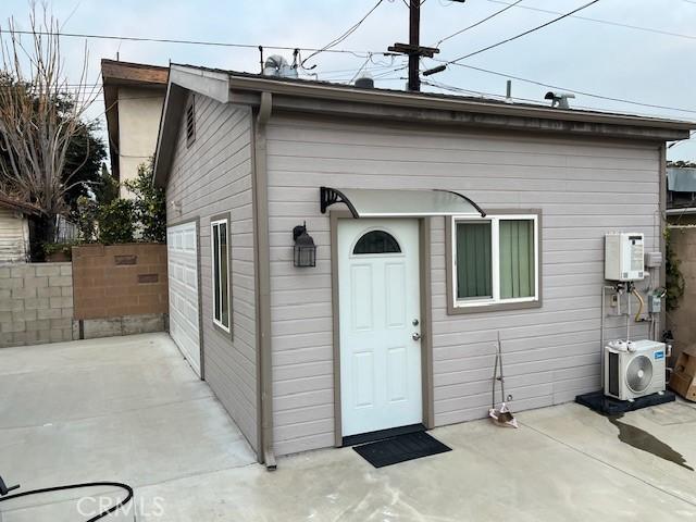 back of house with ac unit and a patio