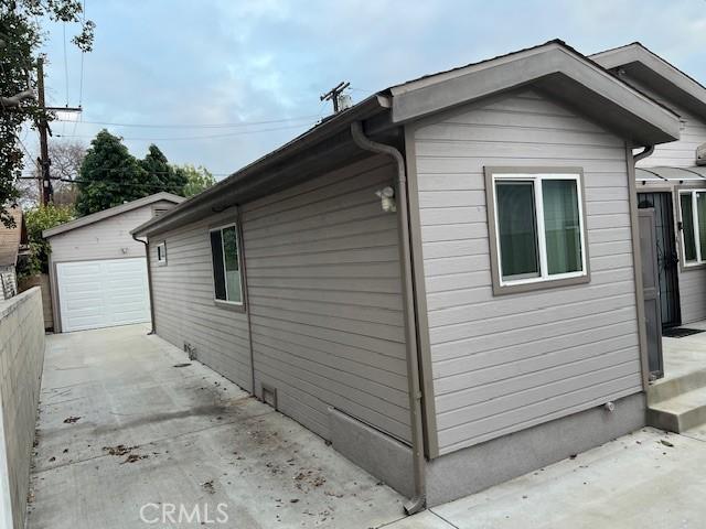 view of home's exterior featuring a garage and an outbuilding