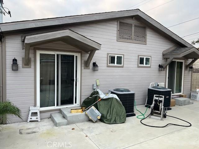 back of house with cooling unit and a patio area