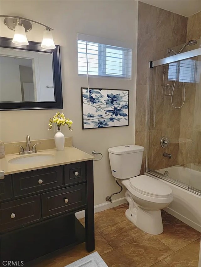 full bathroom with tile patterned flooring, vanity, toilet, and combined bath / shower with glass door