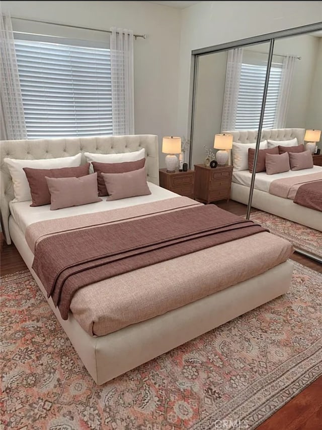 bedroom featuring hardwood / wood-style flooring and a closet