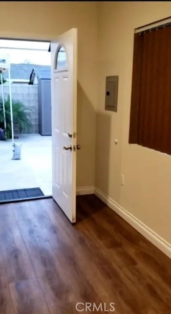 doorway featuring electric panel and dark hardwood / wood-style floors