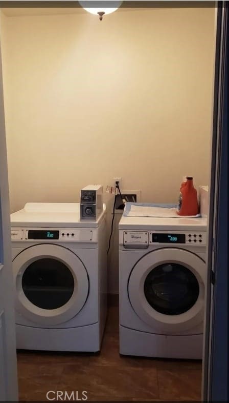 laundry area featuring separate washer and dryer and dark wood-type flooring