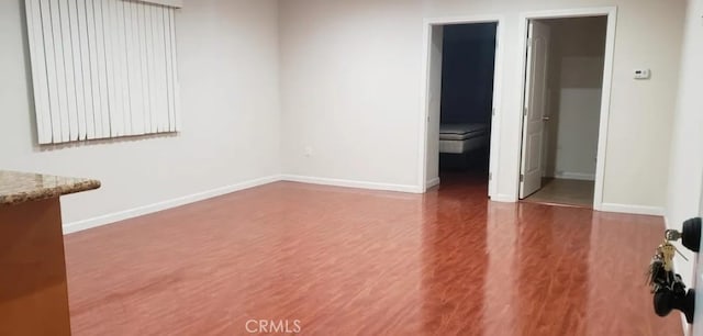 empty room with hardwood / wood-style floors