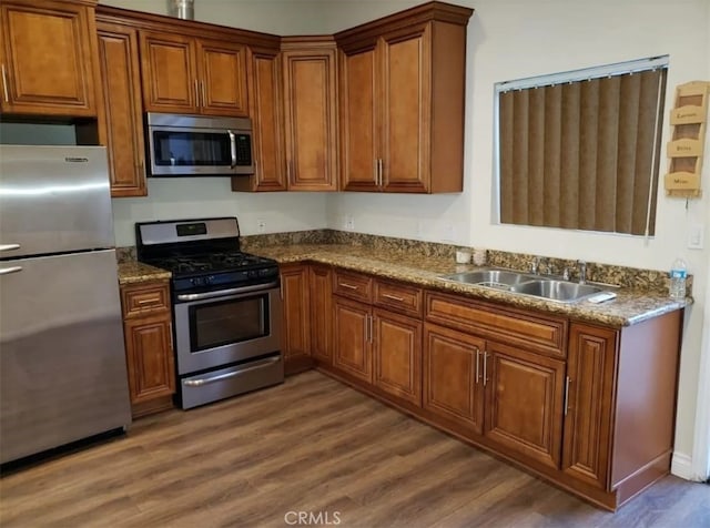 kitchen with sink, dark hardwood / wood-style floors, and appliances with stainless steel finishes