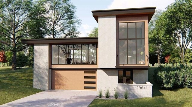 view of front of home with a garage and a front lawn