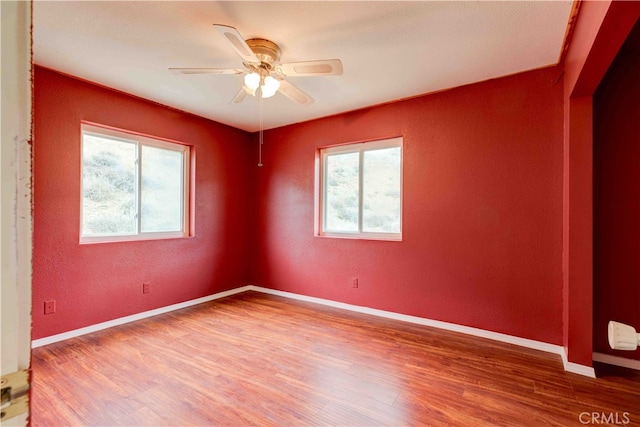 spare room featuring ceiling fan and hardwood / wood-style floors