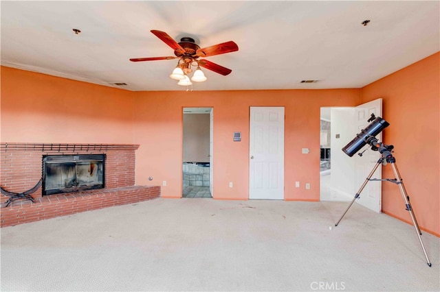 carpeted living room with ceiling fan and a brick fireplace