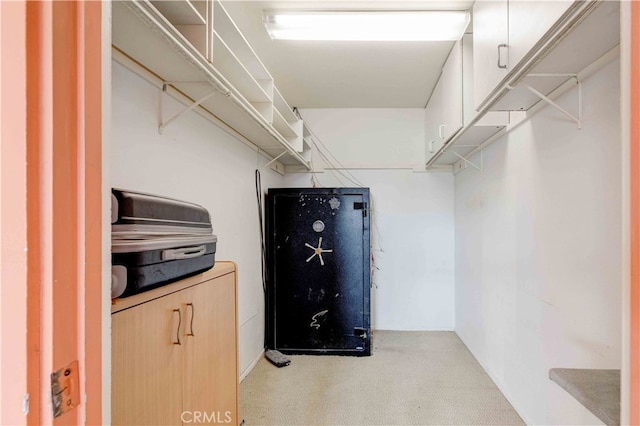 spacious closet featuring light carpet