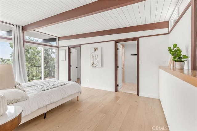 bedroom with floor to ceiling windows, light wood-type flooring, a closet, and beamed ceiling