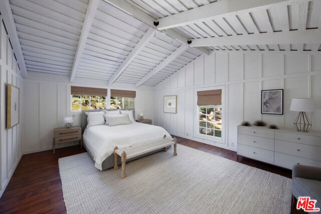 bedroom featuring vaulted ceiling with beams, dark hardwood / wood-style flooring, and multiple windows