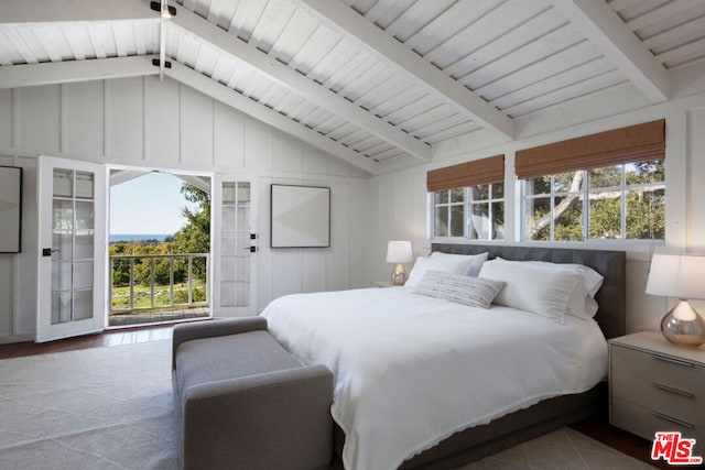 bedroom with access to outside, multiple windows, and vaulted ceiling with beams