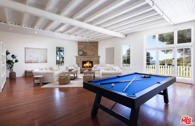 game room with a stone fireplace, beamed ceiling, wood-type flooring, and pool table