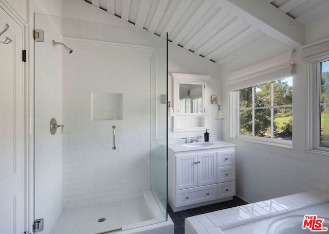 bathroom with vaulted ceiling with beams, vanity, a healthy amount of sunlight, and a shower with shower door