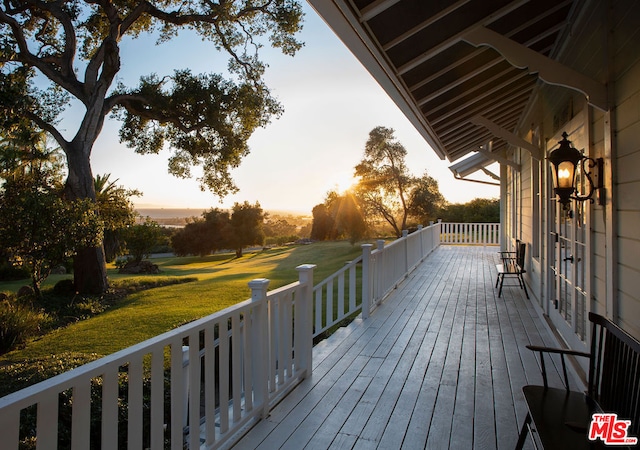 deck at dusk with a yard