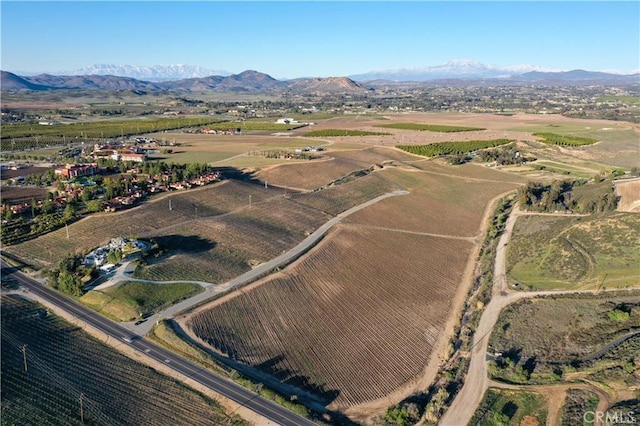 drone / aerial view featuring a mountain view and a rural view