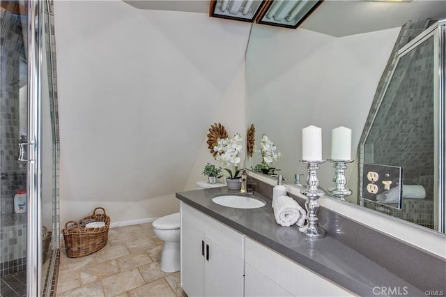 bathroom with a shower with shower door, toilet, and vanity