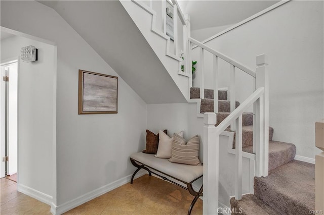 stairs featuring vaulted ceiling