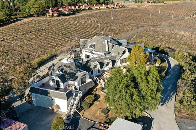 birds eye view of property with a rural view