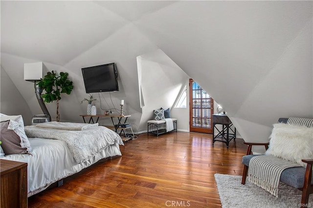 bedroom with hardwood / wood-style floors and vaulted ceiling