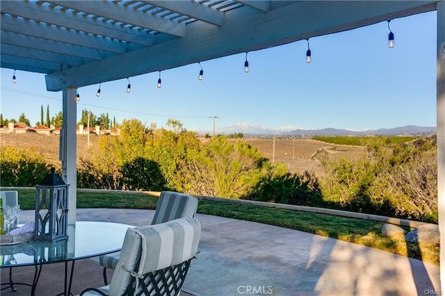 view of patio / terrace featuring a mountain view and a pergola