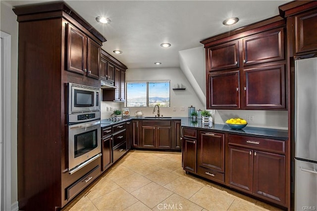 kitchen with sink, light tile patterned flooring, and appliances with stainless steel finishes