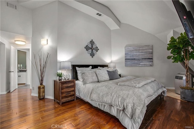 bedroom with hardwood / wood-style flooring and vaulted ceiling