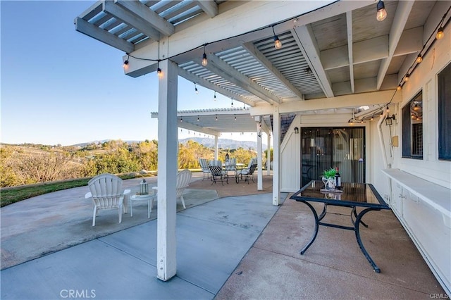 view of patio featuring a mountain view and a pergola