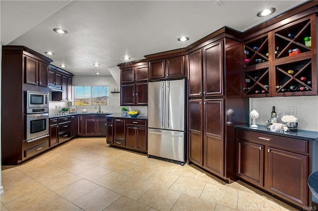 kitchen featuring sink, light tile patterned floors, and appliances with stainless steel finishes