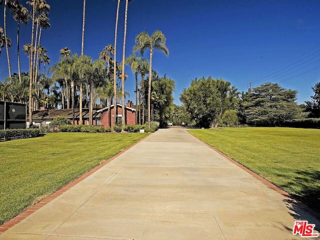 view of home's community with a yard