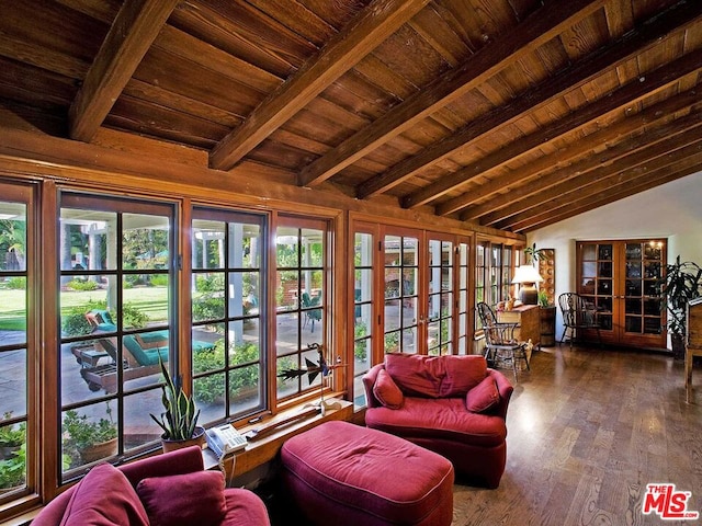 sunroom featuring lofted ceiling with beams, a wealth of natural light, wood ceiling, and french doors