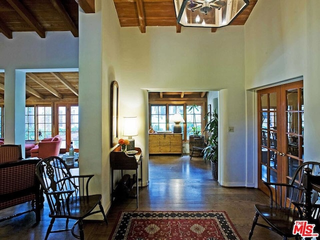 foyer with wooden ceiling, french doors, dark wood-type flooring, and plenty of natural light