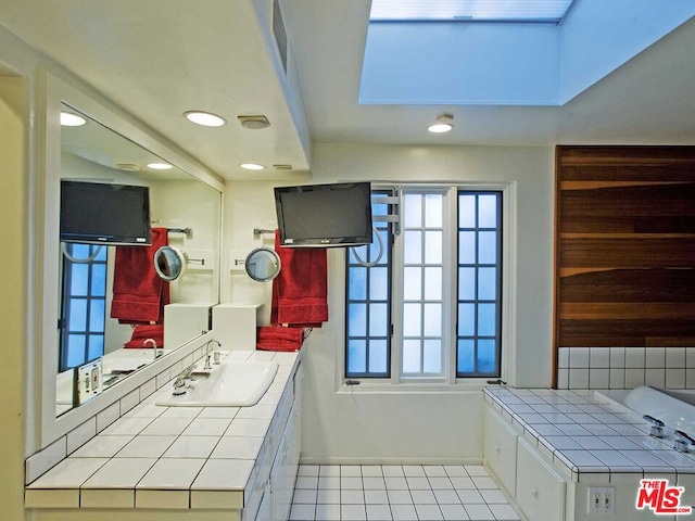 bathroom with tile flooring and vanity with extensive cabinet space