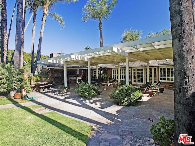 back of property with a patio and a pergola