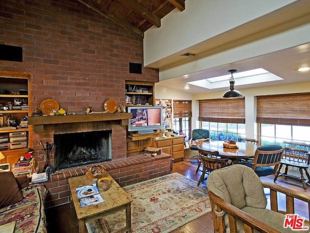 living room featuring dark hardwood / wood-style flooring, brick wall, a brick fireplace, and lofted ceiling with skylight